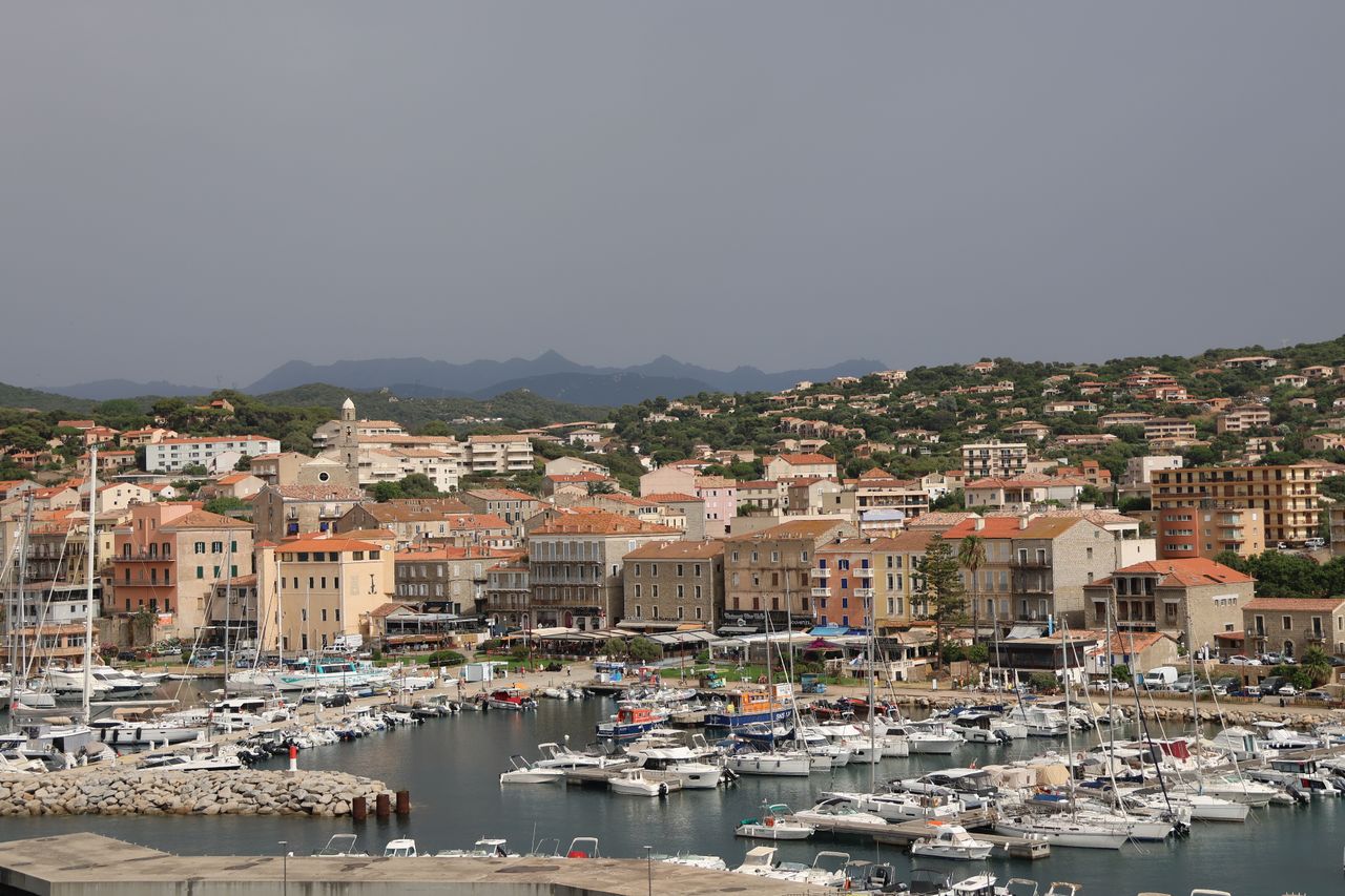 Boats moored in a coastal harbor town